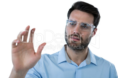 Man wearing protective eyewear pretending to touch an invisible object