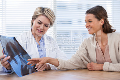 Female doctor explaining x-ray report to patient