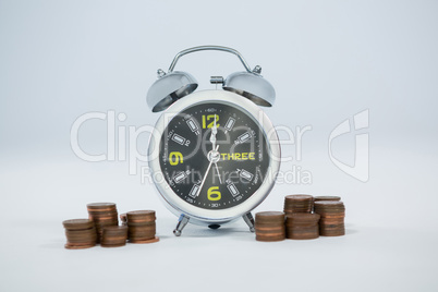 Alarm clock with stack of coins