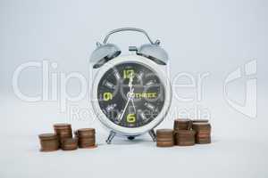 Alarm clock with stack of coins