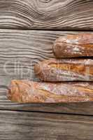 Baguettes on wooden background