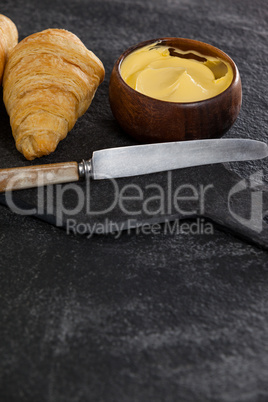 Croissants with butter and knife