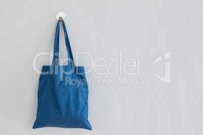 Blue bag hanging on wall