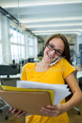 Female business executive talking on mobile phone in office