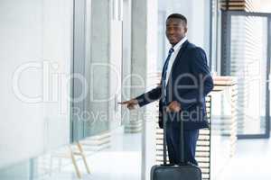 Businessman pressing the button for an elevator