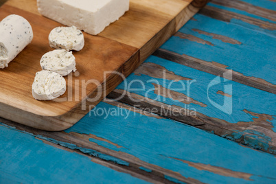 Cheese arranged on chopping board