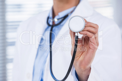 Female doctor showing stethoscope