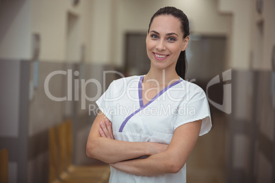Portrait of female nurse standing in corridor