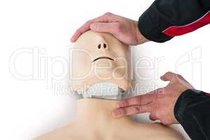 Paramedic practising resuscitation on dummy