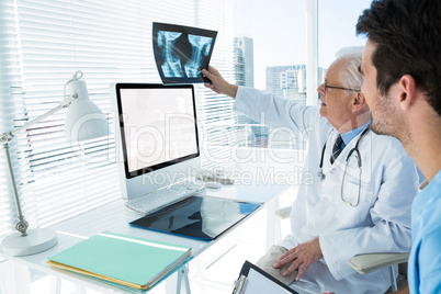 Surgeon and doctor discussing x-ray report