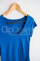 Blue t-shirt hanging on hanger