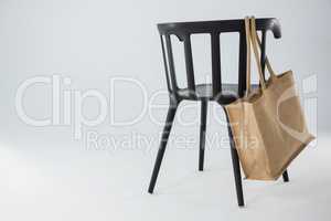 Jute bag hanging on a black chair