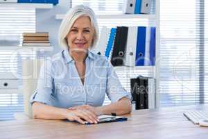 Portrait of doctor sitting at his desk