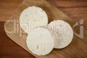 Slices of cheese on chopping board