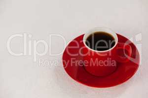 Red coffee cup on saucer