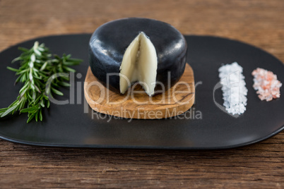 Cheese, rosemary herbs and sea salt on slate plate