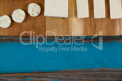 Variety of cheese arranged on chopping board