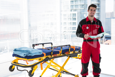 Portrait of handsome paramedic with medical report