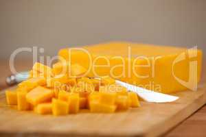 Cubes of cheese with knife