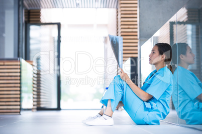 Stressed nurse examining X-ray report