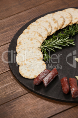 Biscuit, rosemary and sausages on slate board