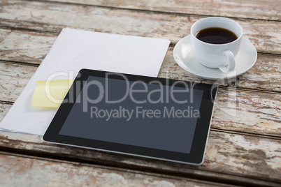 Digital tablet with blank paper and cup of coffee