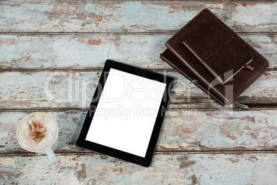 Digital tablet, diary and cup of coffee