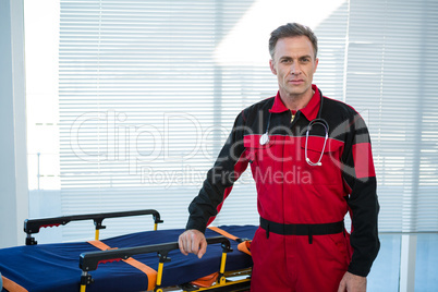 Paramedic standing beside a stretcher