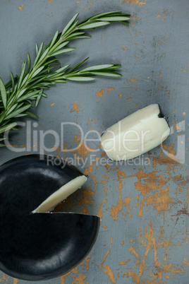 Black cheese with rosemary on wooden background