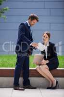 Businessman showing digital tablet to his colleague