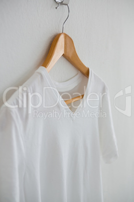 White t-shirt hanging on hanger