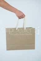Hand of a woman holding shopping bag