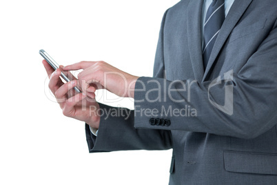 Mid section of businessman using mobile phone