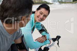 Couple leaning on bicycle while interacting with each other