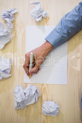 Graphic designer writing on paper