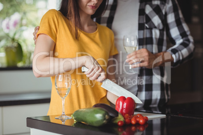 Couple chopping vegetables in kitchen