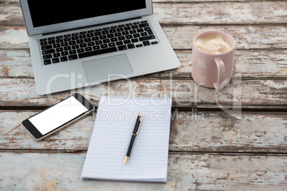 Laptop with smartphone and cup of coffee