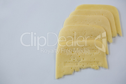Slices of cheese on white background