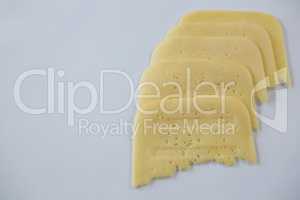 Slices of cheese on white background