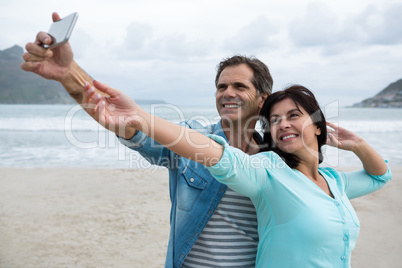 Couple taking selfie on beach