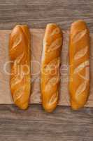 Baguettes on wooden background