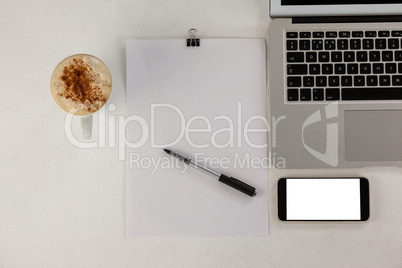 Laptop with smartphone and cup of coffee