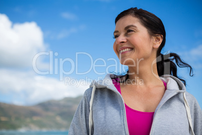 Smiling woman looking away while standing