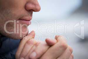 Close-up of man with hands clasped