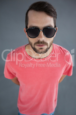 Handsome man in pink t-shirt and sunglasses