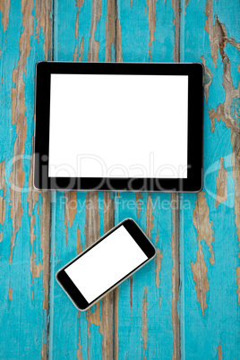 Smartphone and digital tablet on wooden table