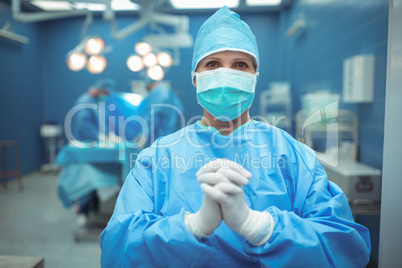 Female surgeon praying in operation theater