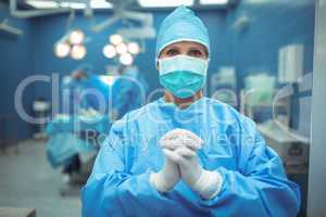 Female surgeon praying in operation theater