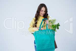 Beautiful woman carrying grocery bag