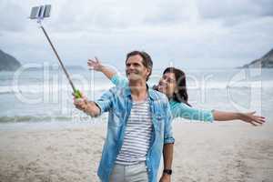 Couple taking selfie on beach